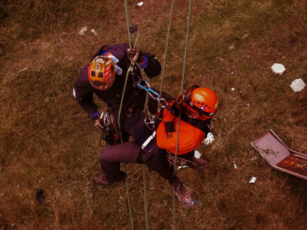 Rope access professionals engaging in technical rescue training during a daring outdoor adventure.