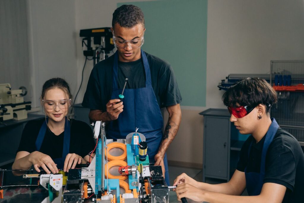 Engineering team working with tools and equipment in a modern workshop.
